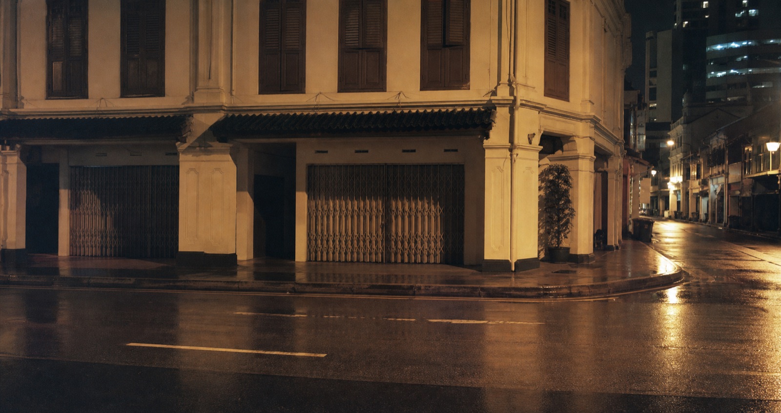 Quiet rain-wet street in Singapore at night